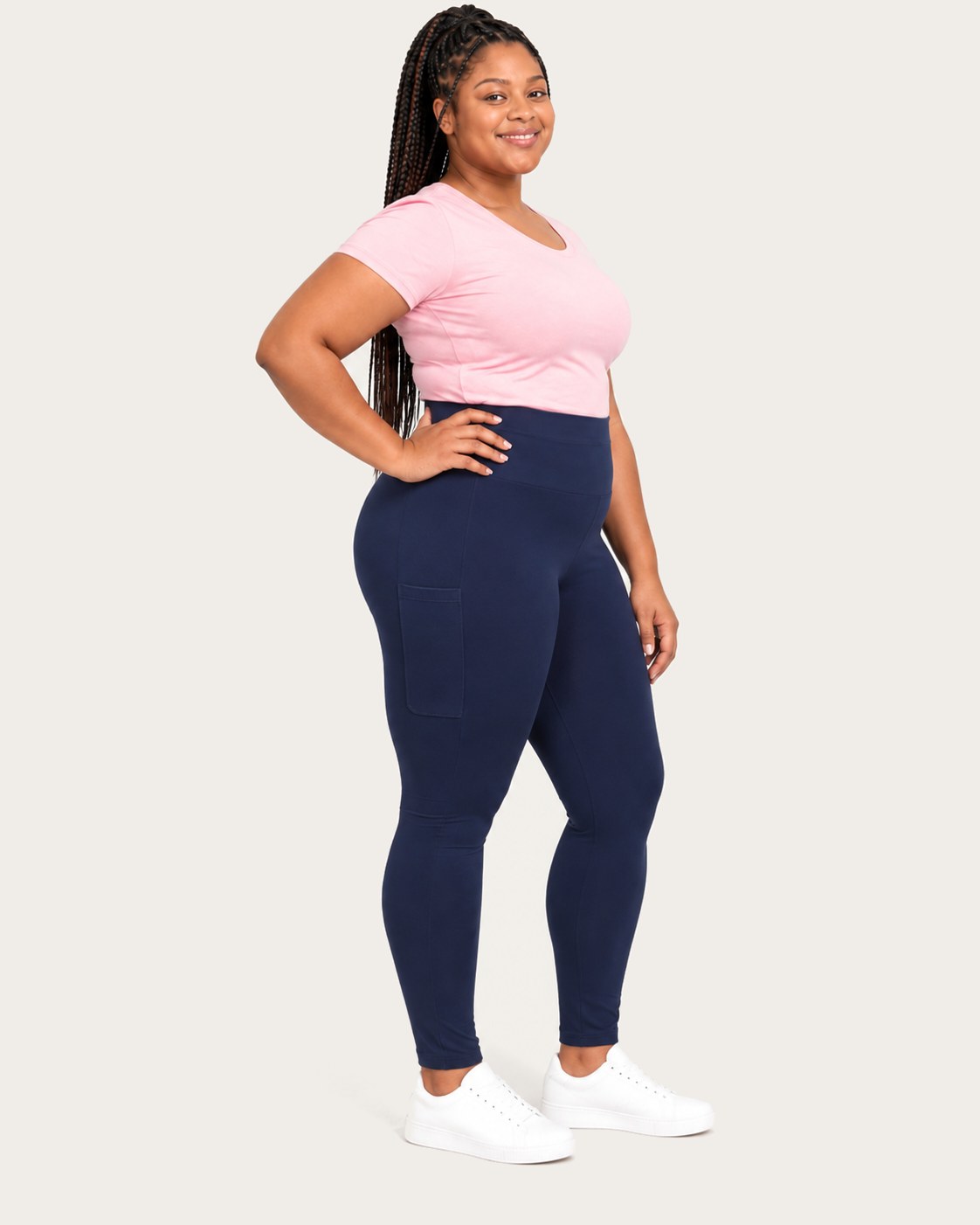 Mom in midnight blue postpartum leggings with side pockets, three-quarter view